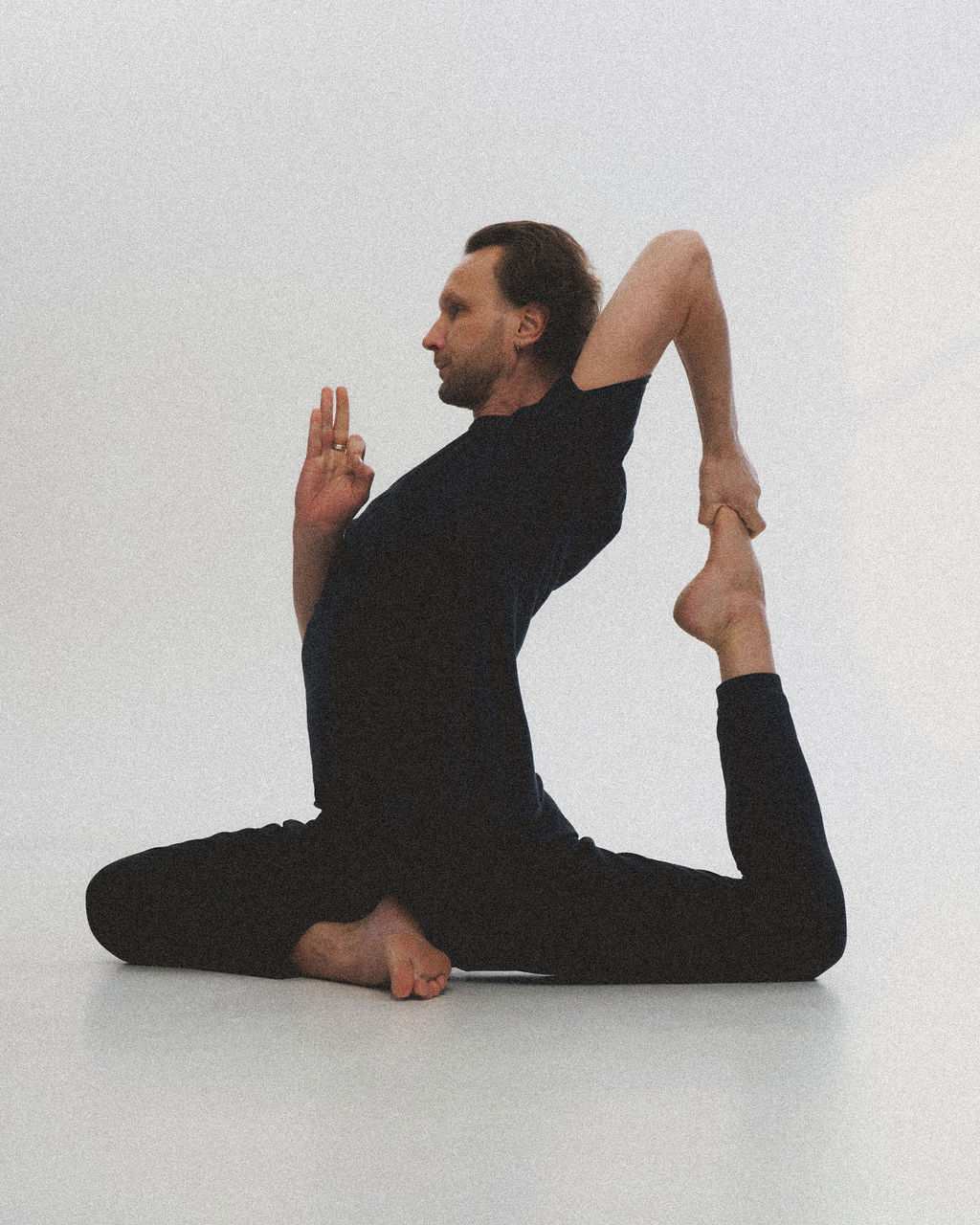 A yoga teacher in pigeon pose